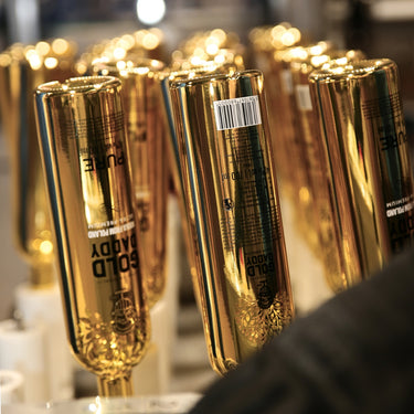 Branded Gold Daddy vodka bottles on the production line