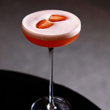 Strawberry martini with fresh strawberry pieces

